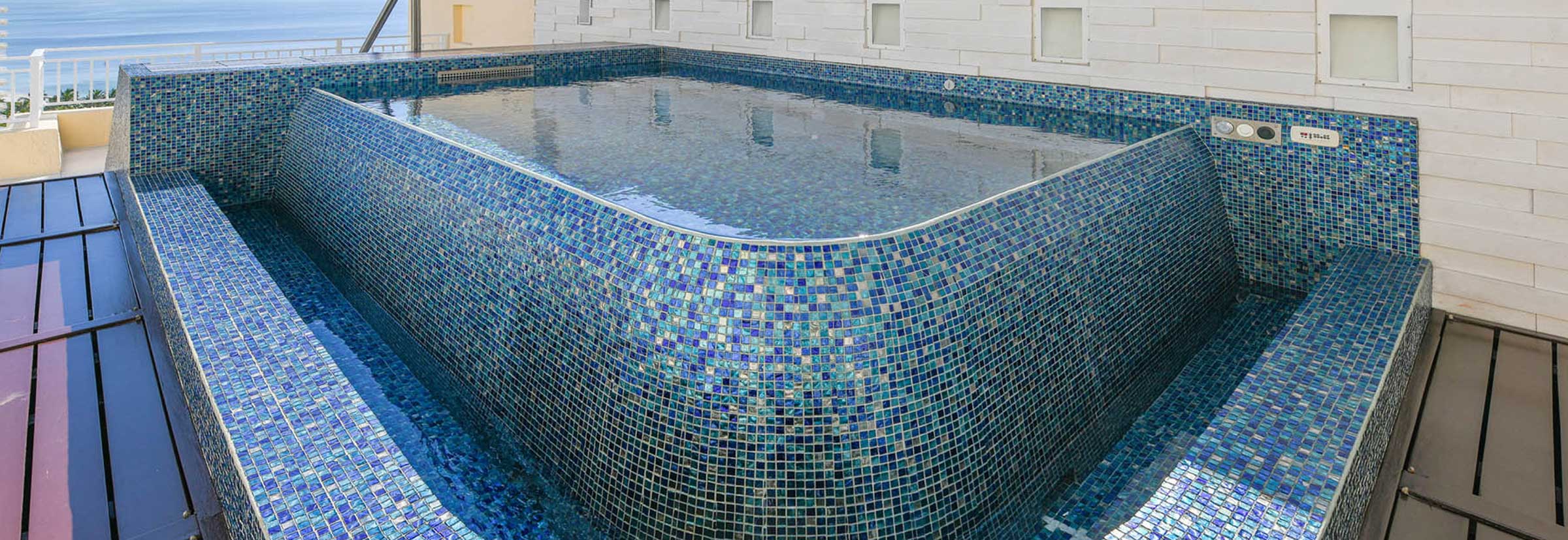 http://Blue%20full%20tile%20swim%20spa%20with%20curved%20edges%20and%20water%20fall